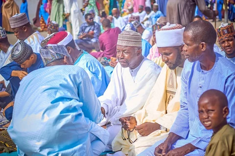 People greeting one another at a community gathering in Nguru